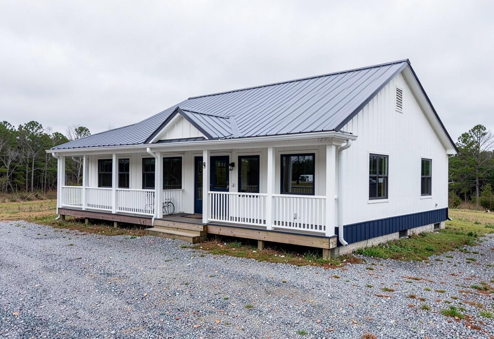 Custom barndominium with metal roof and wraparound porch representing barndominium construction in the Kansas City area