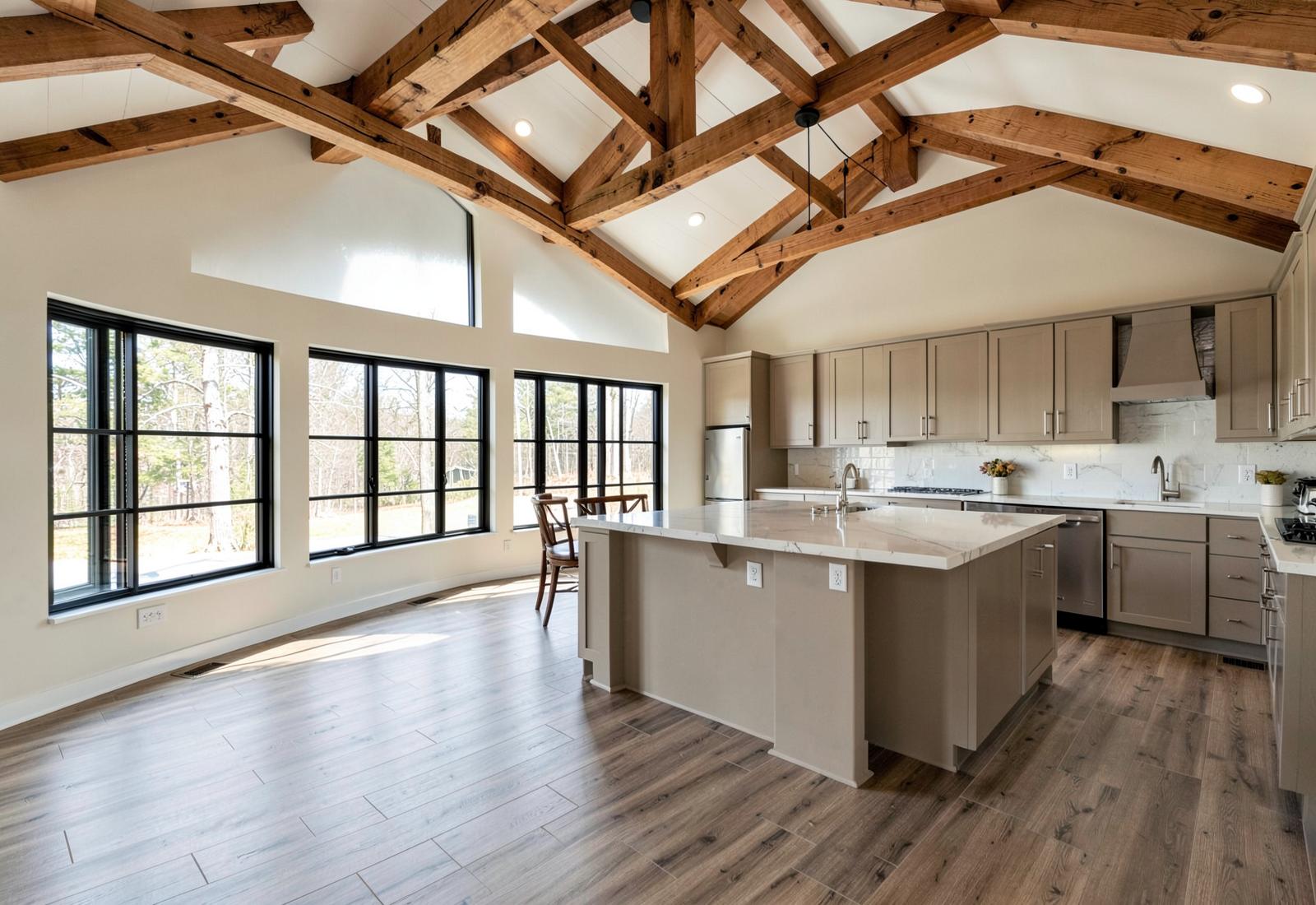 Open-concept barndominium interior with vaulted ceiling and exposed wood trusses